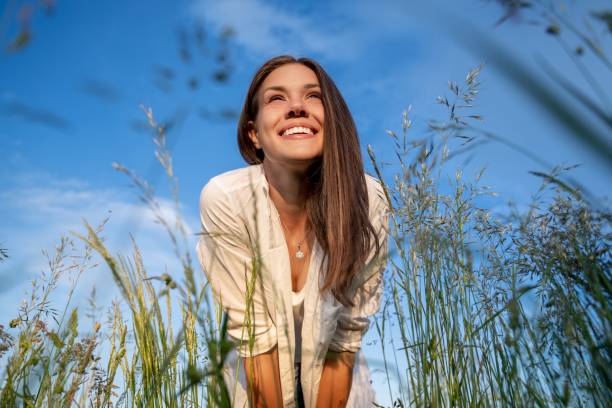 15 Healthy Ways to Spend Your Free Time Low angle view portrait of a woman standing in the meadow Healthy Ways to Spend Your Free Time