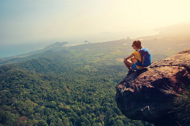 6 Powerful Strategies You Can Start Using Today A woman looking at the view from the top of a mountain.